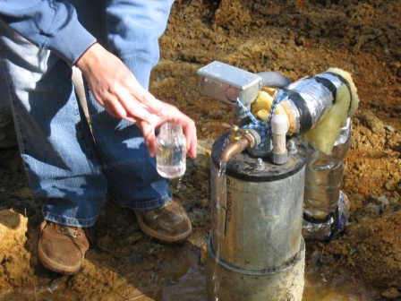 An EHS taking a bacteriological water sample