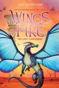 Cover of Wings of Fire Book 11 The Lost Continent. Dragon with blue wings and a green and purple body is looking over his shoulder. Behind him are columns and red desert.