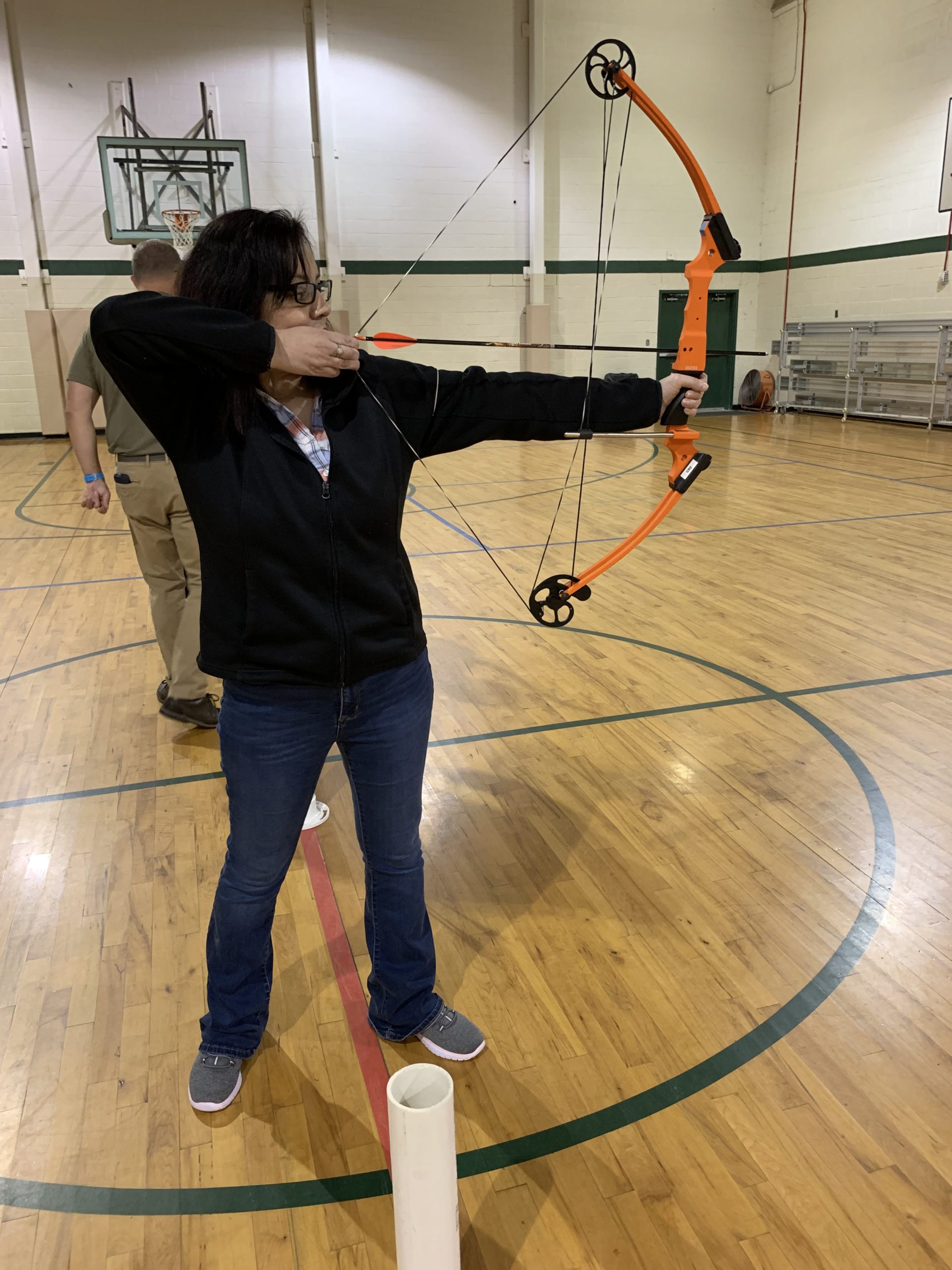 A lady Visually Impaired Program participant shoots an error in a gymnasium 